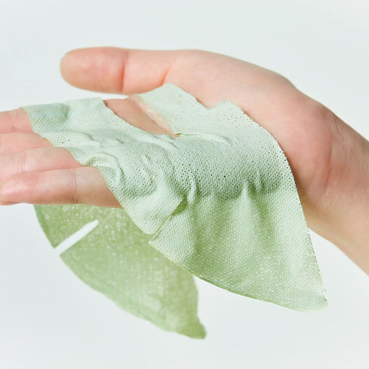Dr.Jart+ Dermask Pore-remedy Purifying Mud Mask 13 g ansiktsmaske i lysegrønt teksturmateriale på en hånd.