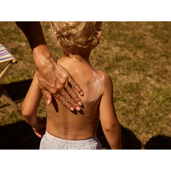 Rudolph Care Sun Lotion Kids SPF30 200 ml solkrem som påføres ryggen til et barn i solen