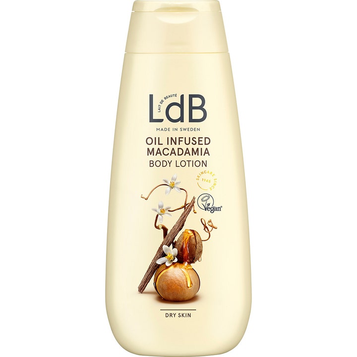 LdB Oil Infused Macadamia Body Lotion pleiende fuktighetskrem for tørr hud i beige flaske med nøtter og hvite blomster.