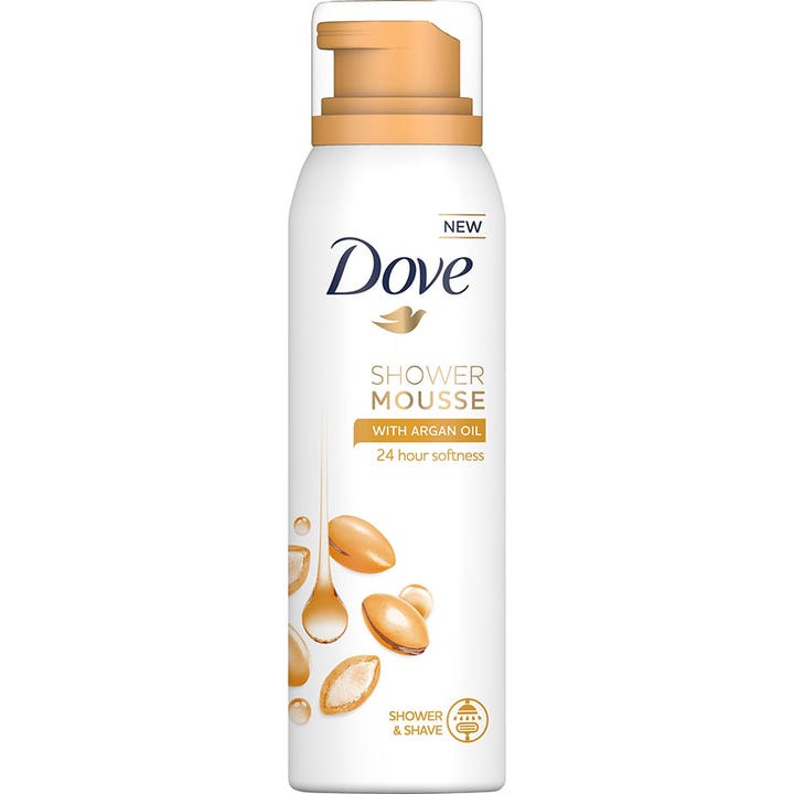 Dove Shower Mousse med Argan Oil fuktighetsgivende dusjskum på hvit sprayflaske med gulldetaljer og argannøtter