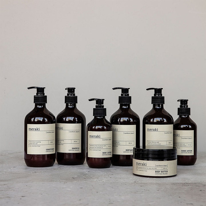 Meraki Northern Dawn Body Lotion 275 ml fuktighetsgivende hudpleie i brun pumpeflaske med andre Meraki produkter