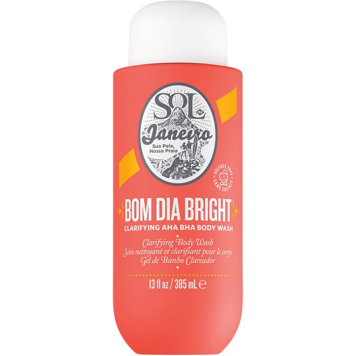Sol de Janeiro Bom Dia Bright 385 ml eksfolierende kroppssåpe i korallrød flaske med hvit kork som gir glød