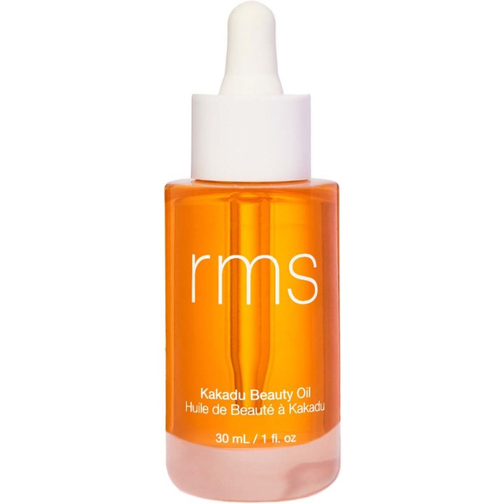 rms Kakadu Beauty Oil 30 ml ansiktsolje som gir glød i en klar glassflaske med oransje olje og hvit pipette.