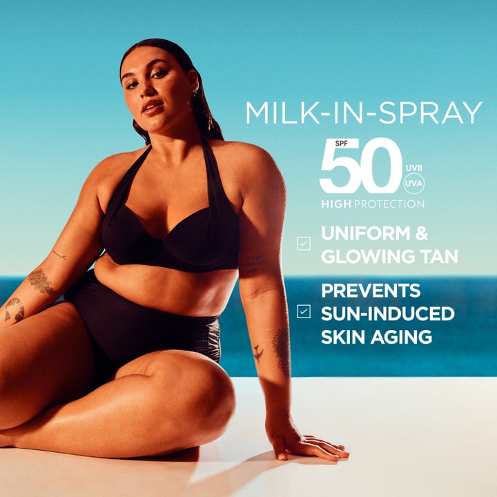 Garnier Ambre Solaire Ideal Bronze Milk-in-Spray 150 ml SPF 50 solkrem gir jevn glød vist med kvinne ved havet