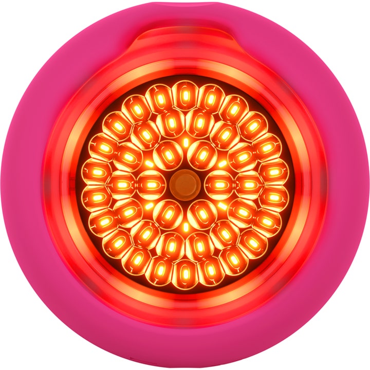 FOREO UFO ansiktsbehandling med LED-terapi viser en rosa enhet med kraftig lysende røde lys i sirkler