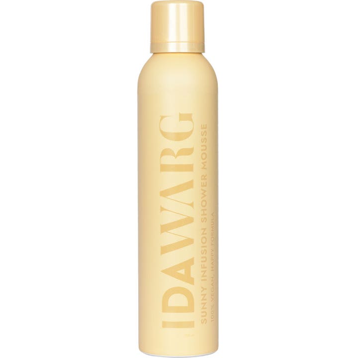 IDA WARG Sunny Infusion Shower Mousse 200 ml vegansk dusjskum i en pastellgul sprayflaske med stor vertikal logo