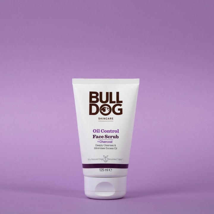 Bulldog Oil Control Face Scrub 125 ml dyprensende ansiktsskrubb med kull i hvit tube mot lilla bakgrunn