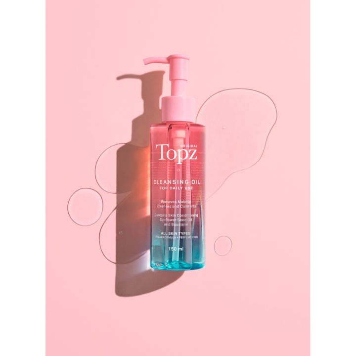 Topz Daily Cleansing Oil 150 ml pleiende ansiktsrengjøring med squalane i rosa og blå pumpeflaske med oljedråper
