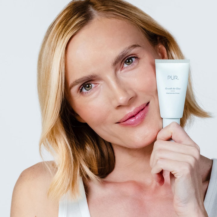 PÜR Go With The Glow Niacinamide Drops 30 ml glødgivende serum vist med en kvinne med strålende hud