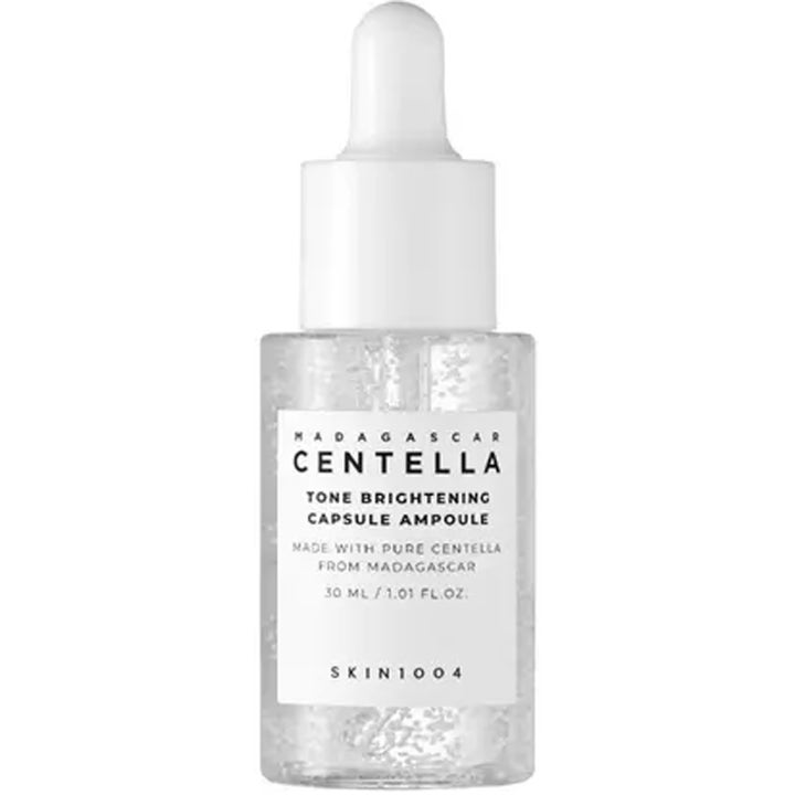 SKIN1004 Madagascar Centella Tone Brightening Capsule Ampoule 30 ml gir glød med hvite kapsler i klar flaske med hvit pipette
