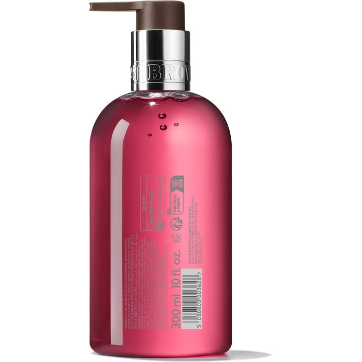 Molton Brown Fiery Pink Pepper Hand Wash 300 ml håndsåpe i rosa flaske med sølvpumpe og baksidelabel med ingredienser.