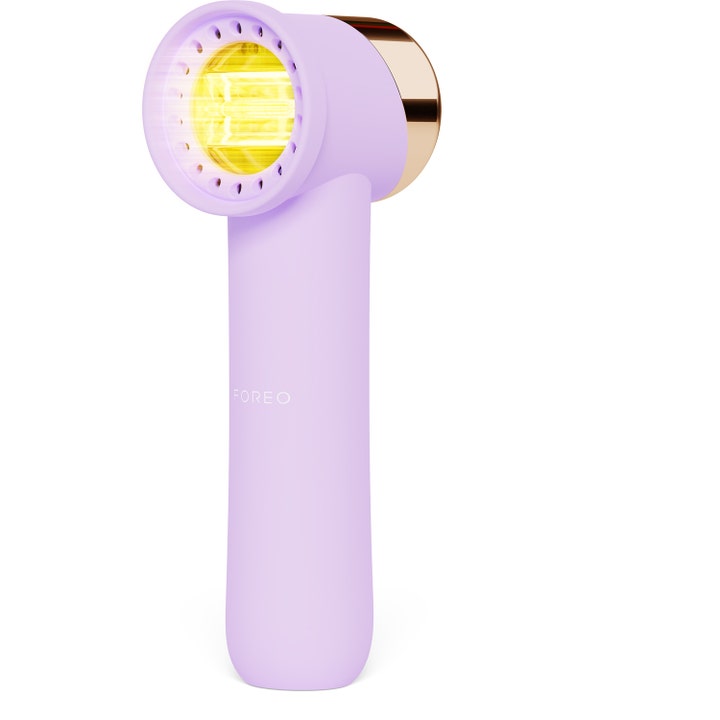 Foreo FAQ 102 ansiktsapparat som gir glød med lilla silikonoverflate og varmt gult LED-lys.