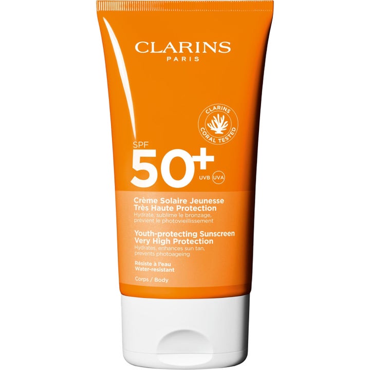 Clarins Youth-protecting Sunscreen SPF 50+ solkrem for kropp i oransje tube med hvit kork