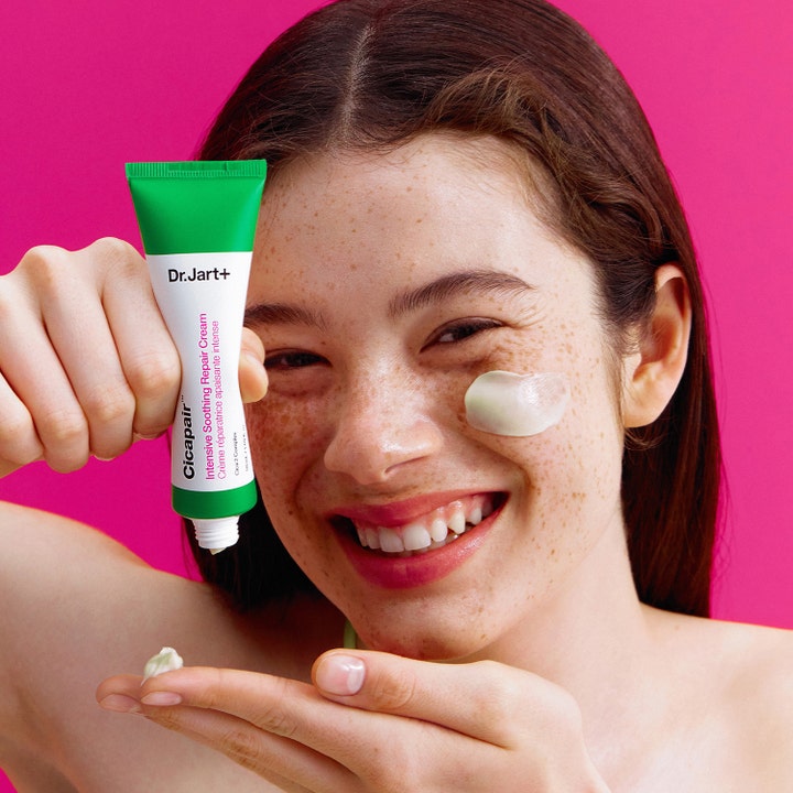Dr.Jart+ Cicapair Intensive Soothing Repair Cream 50 ml beroligende ansiktskrem i grønn tube påført på kinnet til kvinne