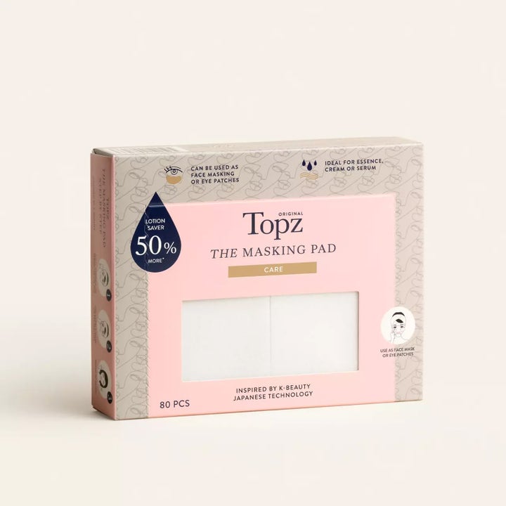 Topz Premium The Masking Pad 80 stk hudpleieverktøy i rosa og beige eske som viser hvite pads i et vindu.