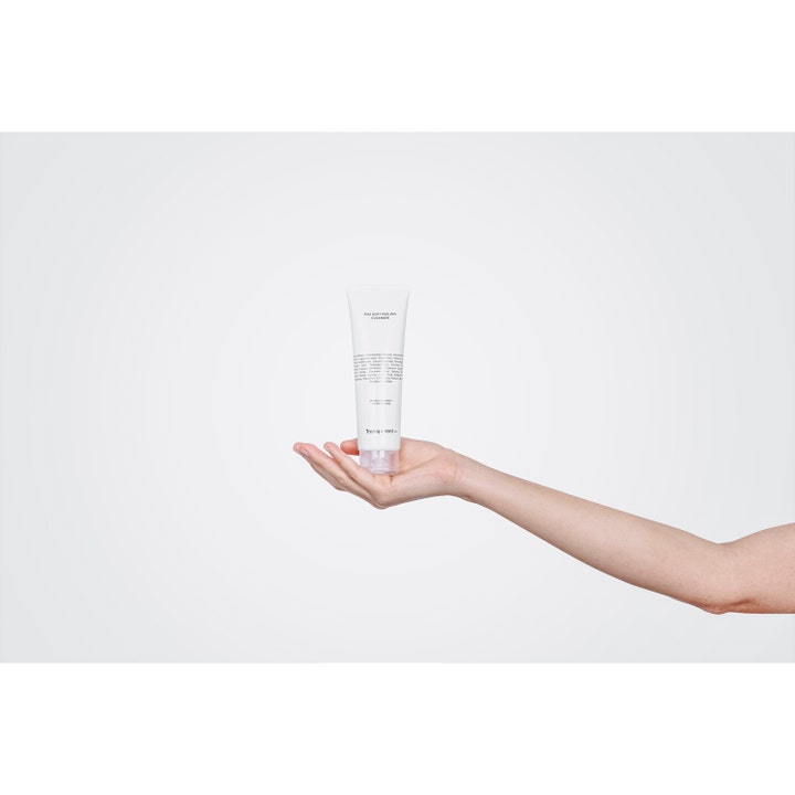 Niche Beauty Lab Transparent Lab pHa Soft Peeling Cleanser 150 ml eksfolierende ansiktsrens i hvit tube holdt i en hånd.