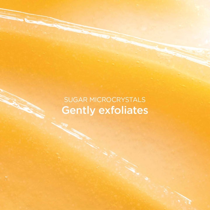 Clarins Comfort Scrub Nourishing Oil Scrub 50 ml ansiktsskrubb med gul oljetekstur og sukkerkrystaller som eksfolierer huden.