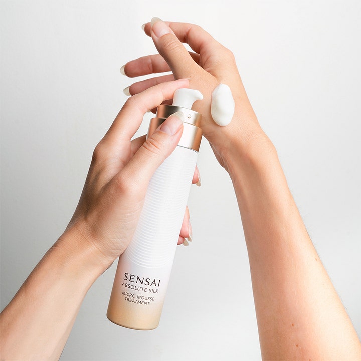 Sensai Absolute Silk Micro Mousse Treatment 90 ml toner gir glød med hvit moussetekstur på hendene fra elegant pumpeflaske