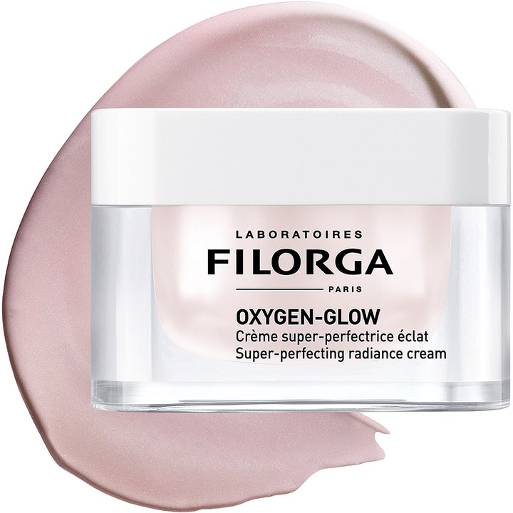 Filorga Oxygen-Glow Cream 50 ml glødgivende dagkrem i krukke foran et strøk av lys rosa, skimrende tekstur.