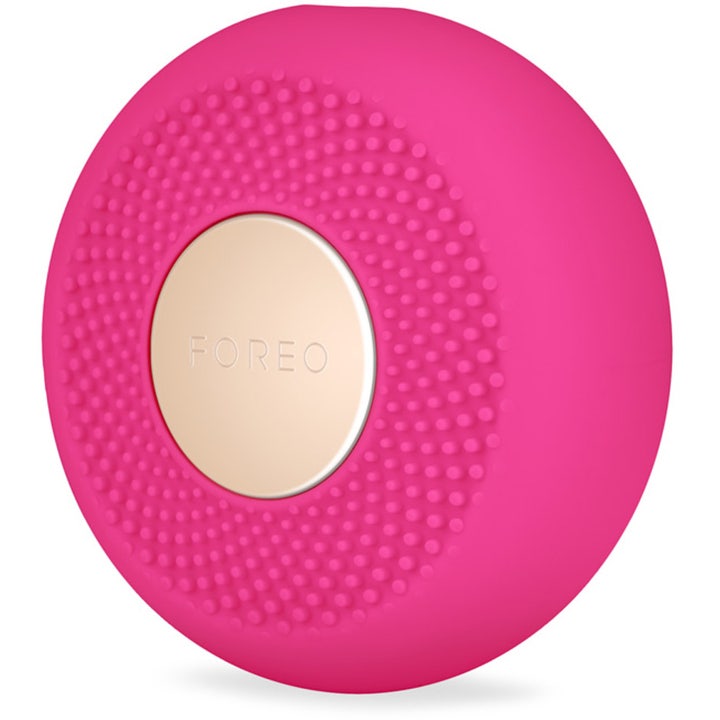 FOREO UFO mini 2 Fuchsia ansiktsenhet som gir glød i fuchsia silikon med nuppete overflate og gullplate.