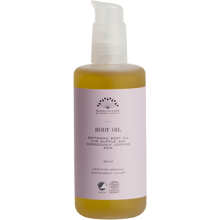 Rudolph Care Body Oil 200 ml mykgjørende kroppsolje i gjennomsiktig flaske med gyllen olje og lyserosa etikett