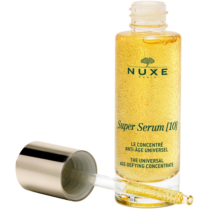 Nuxe Super Serum 30 ml anti-age ansiktsserum i åpen glassflaske med pipette og synlige gylne oljeperler