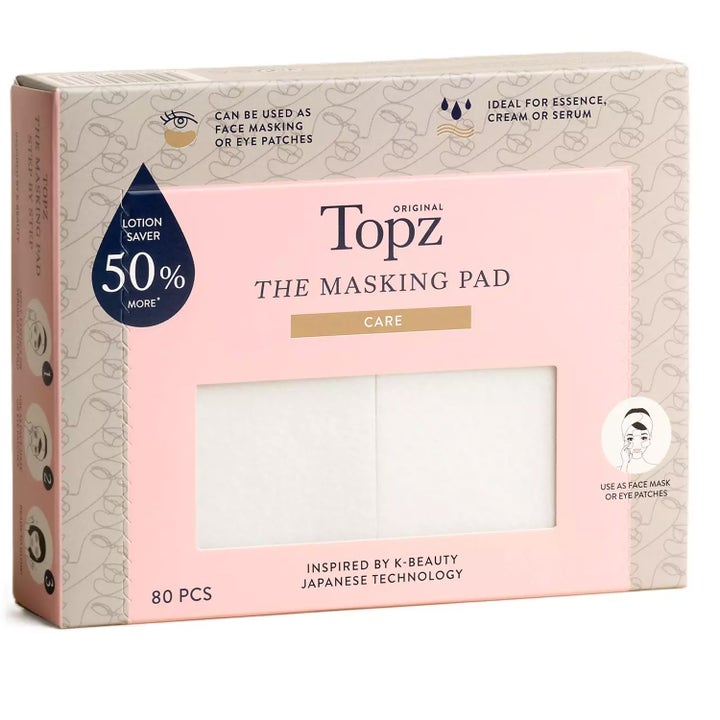 Topz The Masking Pad 80 stk for ansiktsmaske i en lyserosa pappeske med vindu som viser de hvite padsene