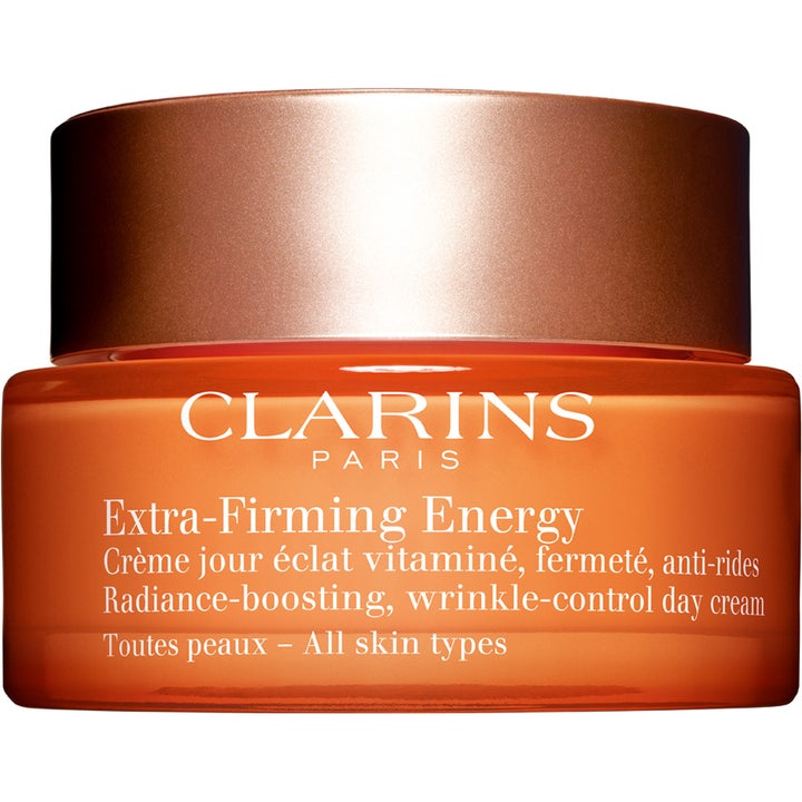 Clarins Extra-Firming Energy 50 ml oppstrammende dagkrem som gir glød i oransje glasskrukke med bronsefarget lokk.