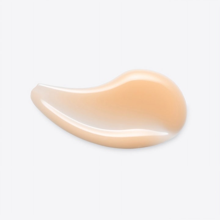 Origins GinZing Into the Glow Brightening Serum 30 ml viser en glatt ferskenfarget tekstur