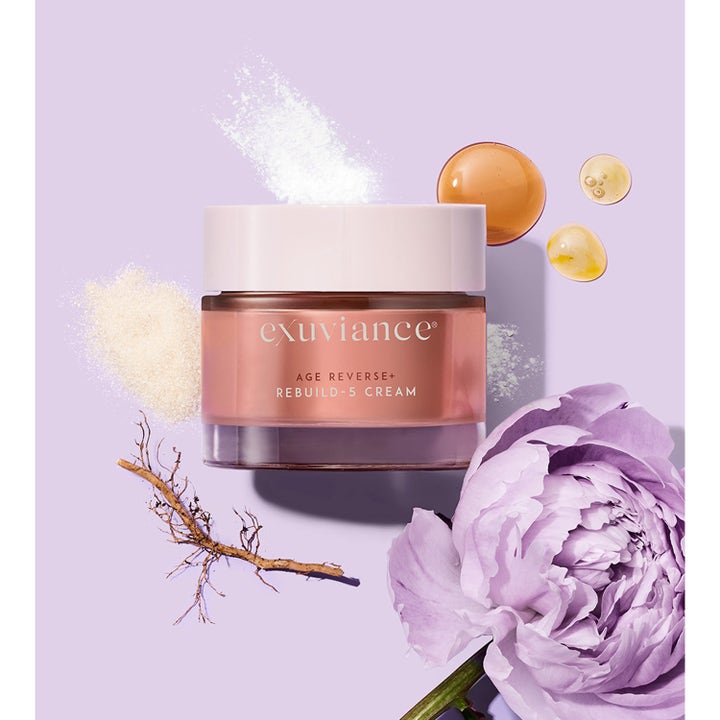 Exuviance Age Reverse + Rebuild-5 Cream 50 ml dagkrem i rosegull krukke med lilla blomst og gyllne oljedråper