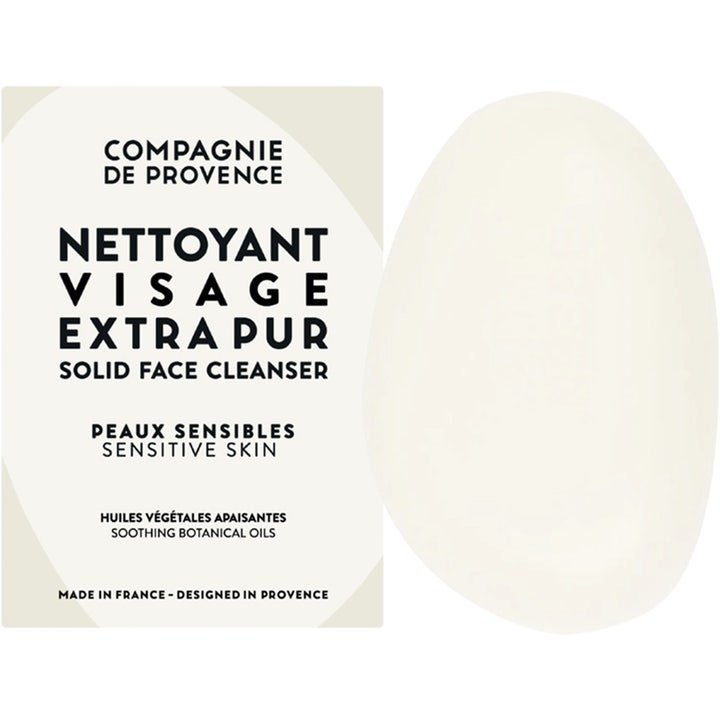 Compagnie de Provence Solid Face Cleanser 85 g beroligende ansiktsrengjøring i fast form med et kremhvitt ovalt såpestykke.