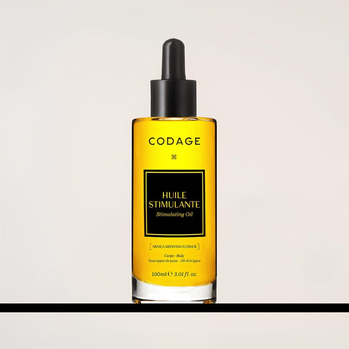 Codage Paris Stimulating Oil 100 ml stimulerende kroppsolje i glassflaske med gul olje og svart pipette.