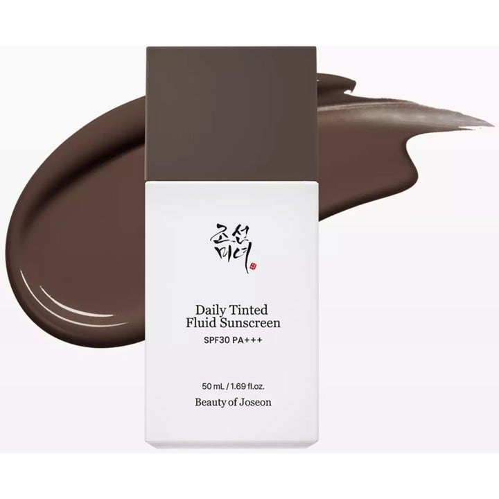 Beauty of Joseon Daily Tinted Fluid Sunscreen 50 ml farget solkrem i hvit flaske med mørkebrun tekstur bak