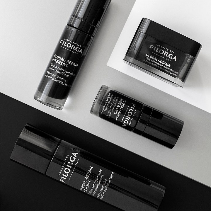 Filorga Global-Repair Intensive Serum 30 ml og hudpleieserie i stilrene svarte flasker på grafisk bakgrunn.
