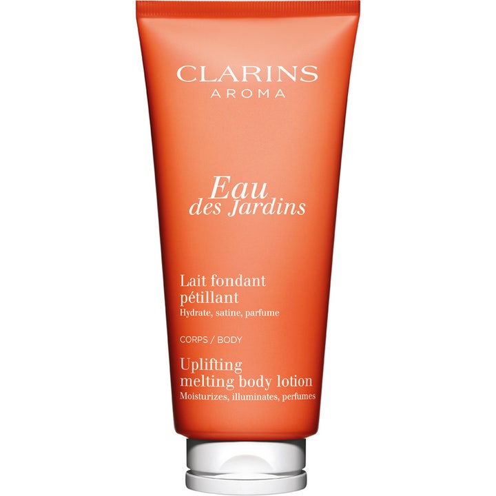 Clarins Eau des Jardins Body Lotion 200 ml fuktighetsgivende krem som gir glød i en oransje tube med hvit kork