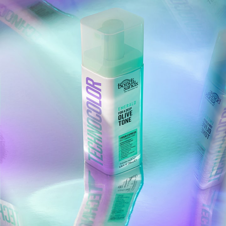Bondi Sands Technocolor Self Tanning Face Serum Emerald 50 ml gir dyp oliventone i hvit pumpeflaske på skimrende bakgrunn.