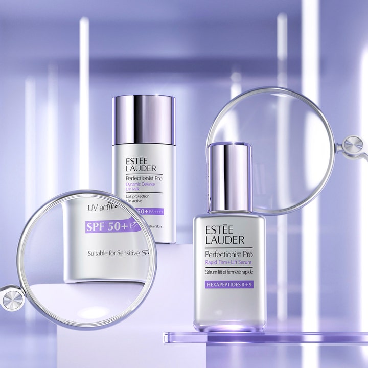 Estée Lauder Perfectionist Pro Rapid Firm + Lift Serum 50 ml i sølvflaske vist gjennom forstørrelsesglass