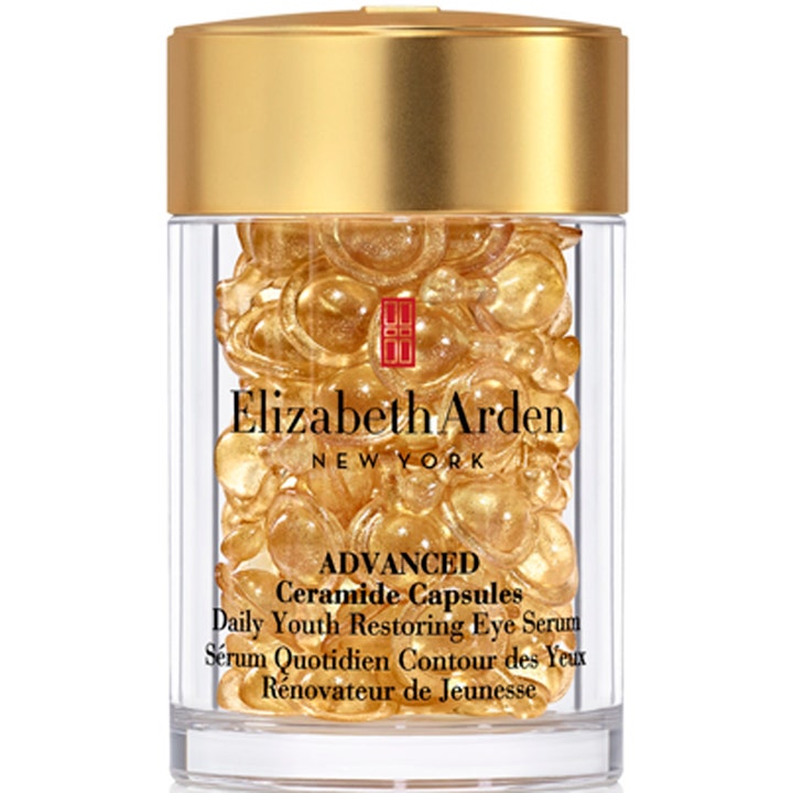 Elizabeth Arden Advanced Ceramide Capsules foryngende øyeserum i en klar krukke fylt med gylne kapsler og et gulllokk.