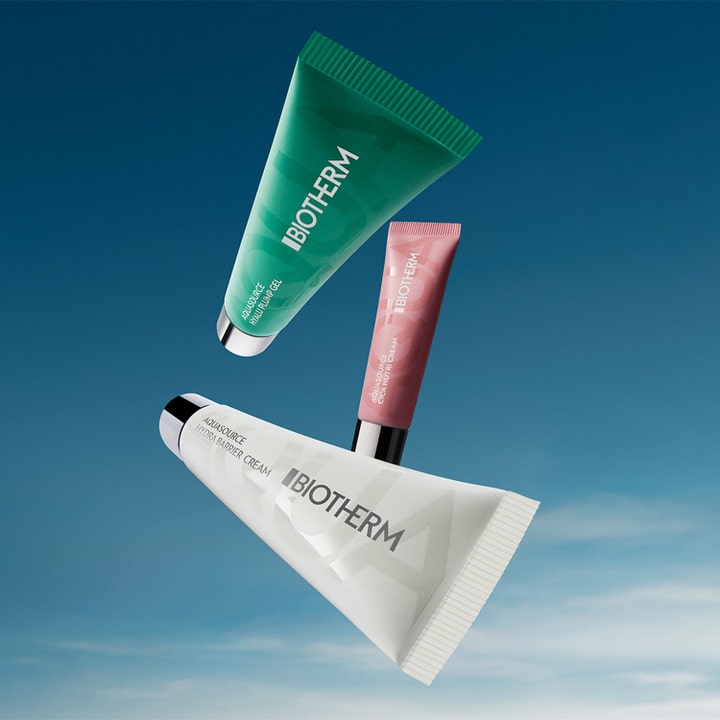 Biotherm Aquasource Cica Nutri Cream 30 ml nærende ansiktskrem i rosa tube svevende mot blå himmel med andre tuber