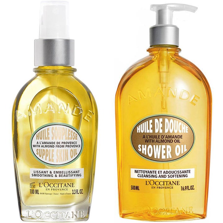 L'Occitane Amande Supple Skin Oil 100ml og Shower Oil 500ml mykgjørende kroppspleie i klare flasker med sølvpumper.