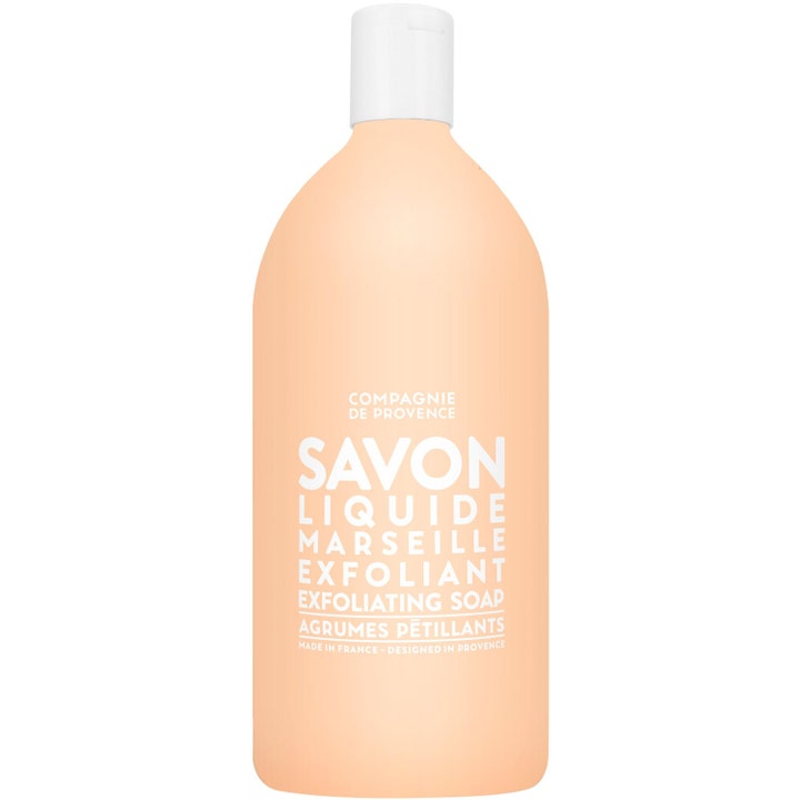 Compagnie de Provence Savon Liquide Marseille 1000 ml eksfolierende såpe i ferskenfarget flaske med hvit kork.
