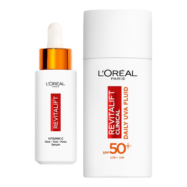 L'Oréal Paris Revitalift Clinical Vitamin C Serum og SPF 50+ Fluid glødgivende ansiktspleie i hvite flasker med pipette