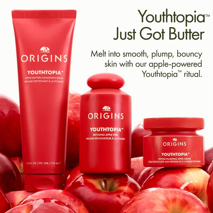 Origins Youthtopia Apple Butter Cleansing Balm 125 ml ansiktsrengjøring i rød tube omgitt av friske røde epler