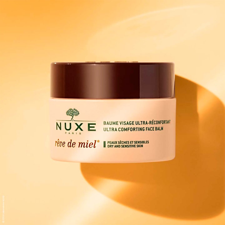 Nuxe Rêve de Miel 50 ml beroligende ansiktskrem for tørr hud i en beige krukke med mørkebrunt lokk.