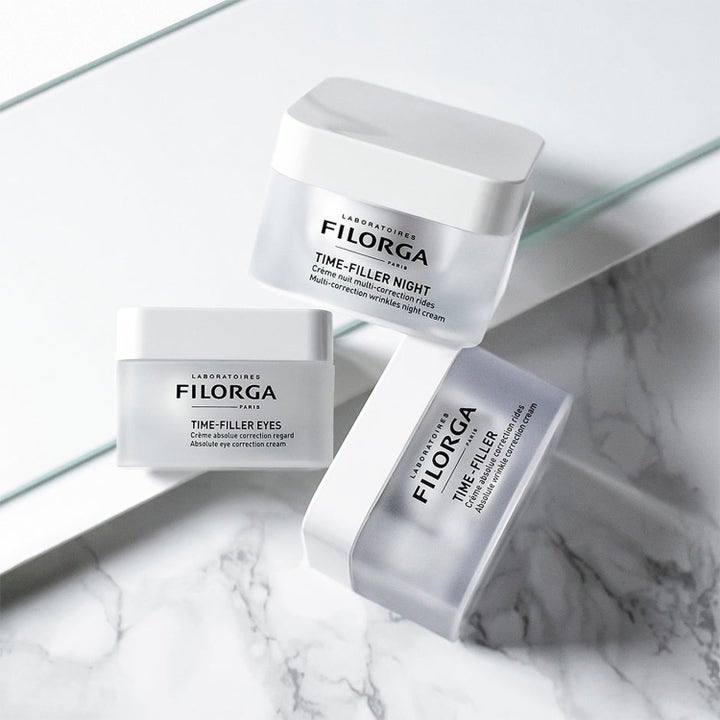 Filorga Anti-Wrinkle Night Time Set rynkekorrigerende hudpleiesett med tre krukker i frostet glass på marmor.