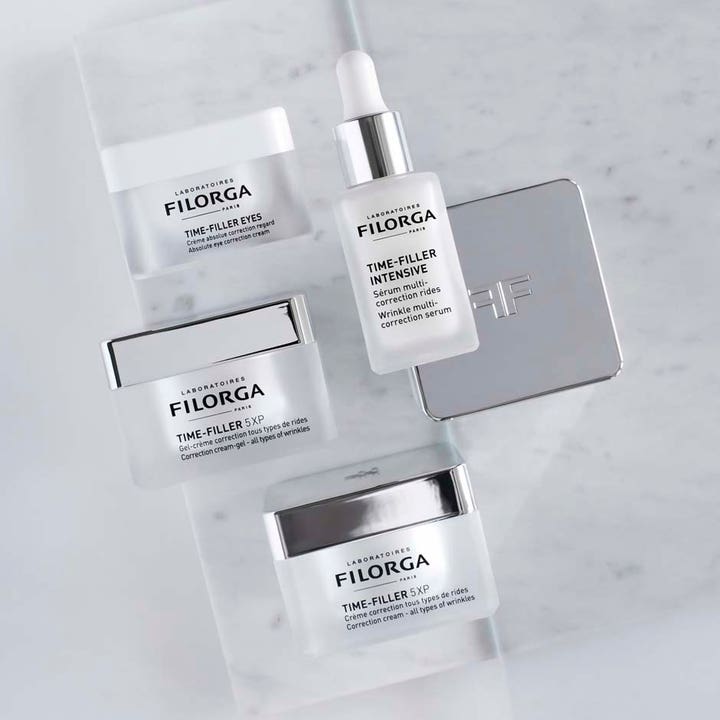 Filorga Time-Filler 5XP Cream 50 ml rynkekorrigerende ansiktskrem vist i en produktserie på lys marmorbakgrunn