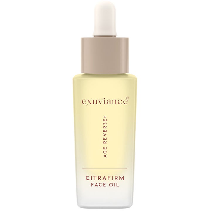 Exuviance Age Reverse+ Citrafirm Face Oil oppstrammende ansiktsolje i en frostet glassflaske med beige dråpeteller.