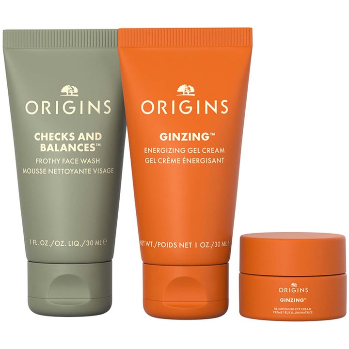 Origins Mini Travel Essentials Trio hudpleiesett med GinZing gelkrem, øyekrem og ansiktsvask i oransje og grønne tuber.