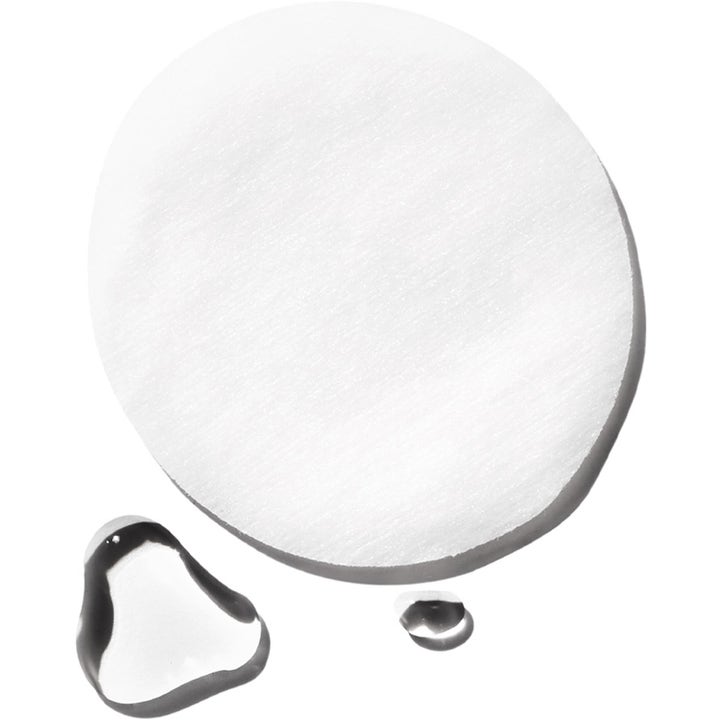 Exuviance Gentle Daily Exfoliating 60 pads peeling som gir glød viser en hvit rund pad og klare væskedråper