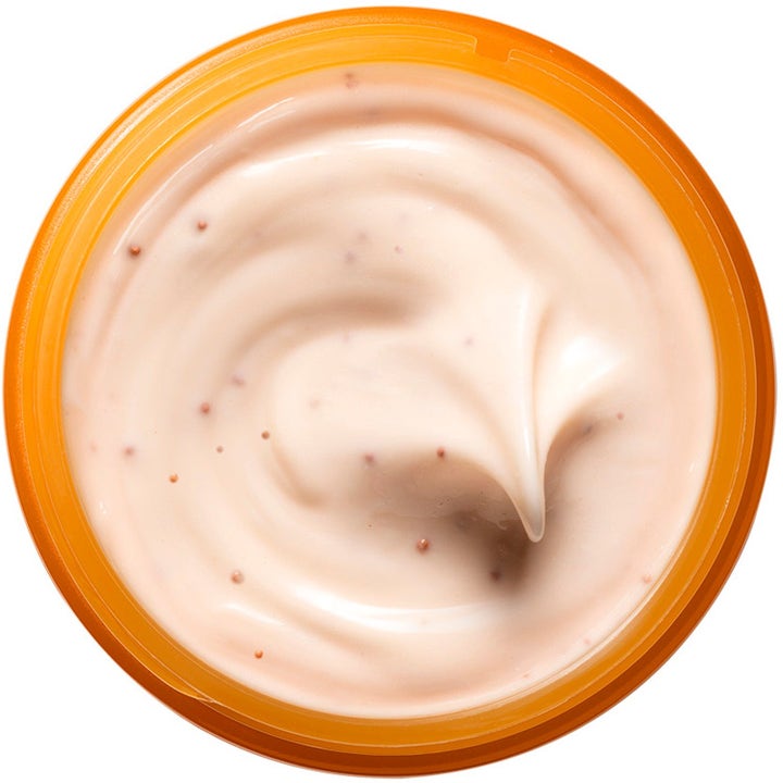 Origins Ljusare Hy 125 ml ansiktsmask med kremet ferskenfarget tekstur og små korn i en oransje krukke